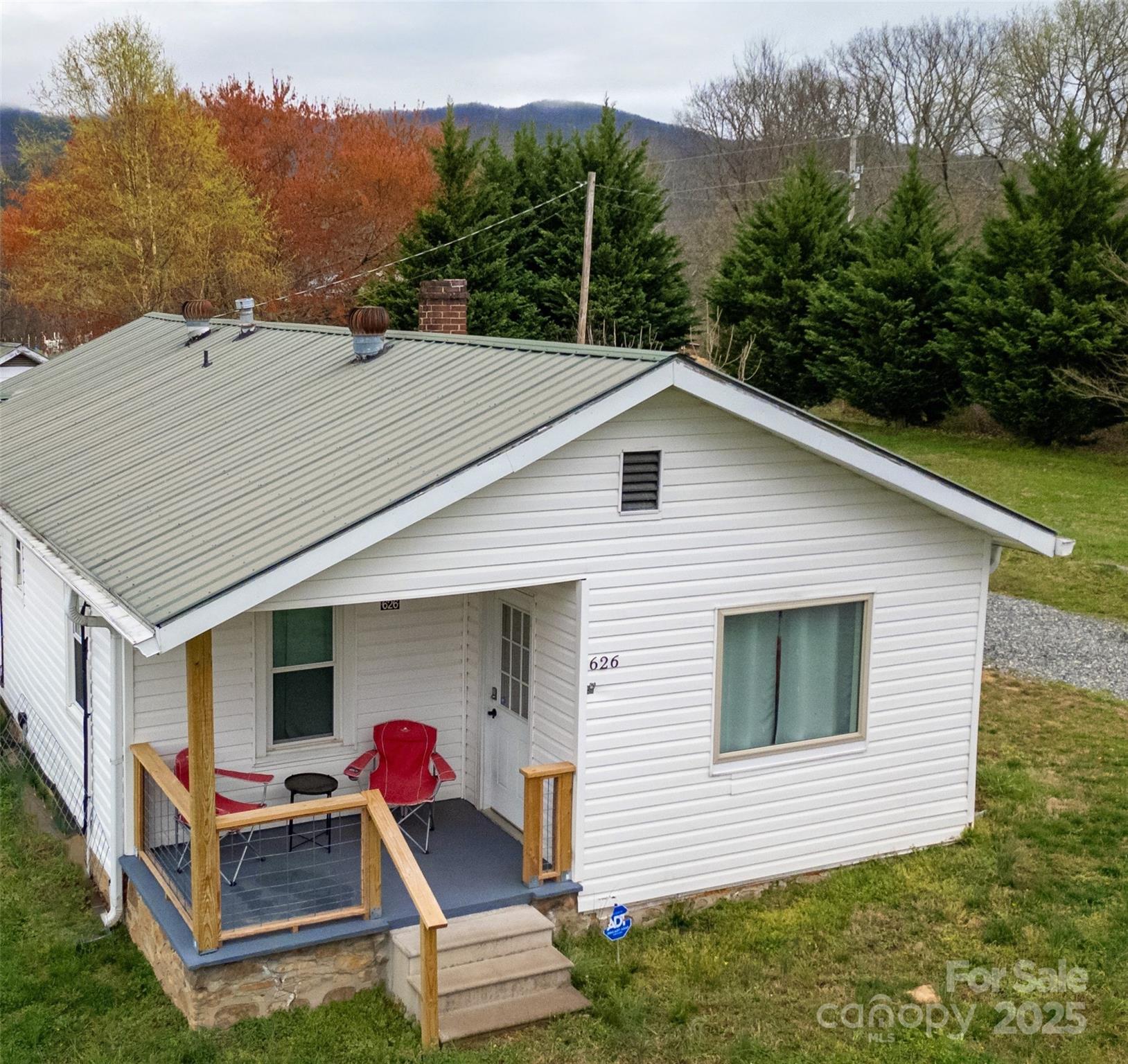 a view of house with backyard space and garden