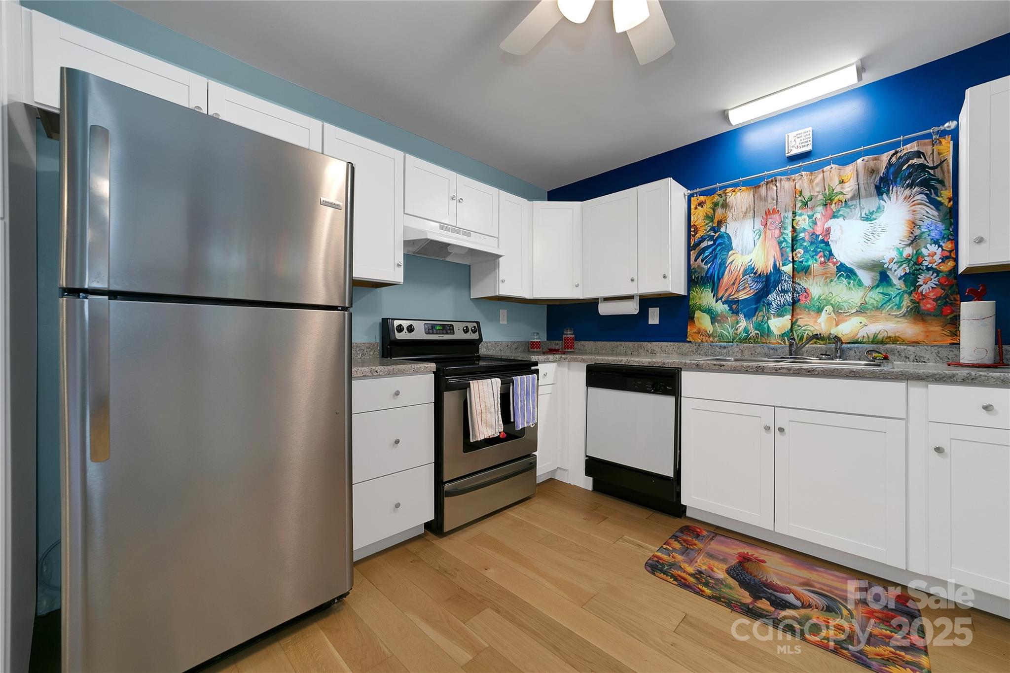 626 Fairview Loop Hot Springs, NC 28743 - Photo 16 of 44 a kitchen with stainless steel appliances a refrigerator sink and white cabinets