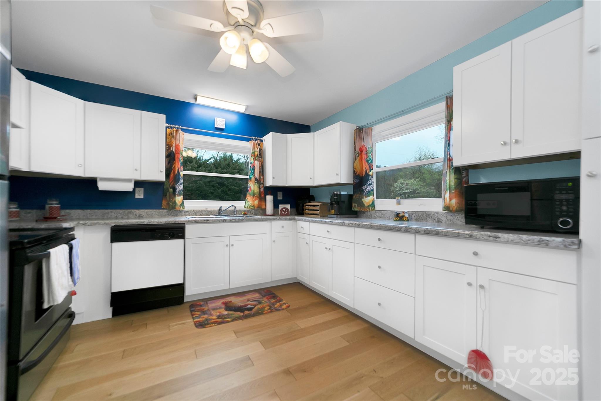 626 Fairview Loop Hot Springs, NC 28743 - Photo 17 of 44 a kitchen with granite countertop a stove a sink and white cabinets