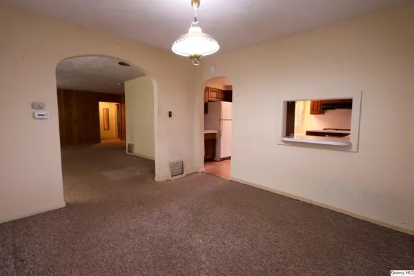 a view of a room with a hanging light and closet