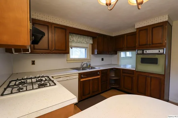 a kitchen with a sink a stove and cabinets