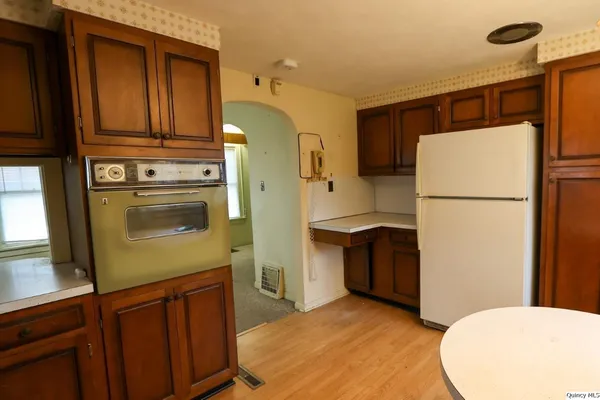 a kitchen with a refrigerator sink stove and cabinets
