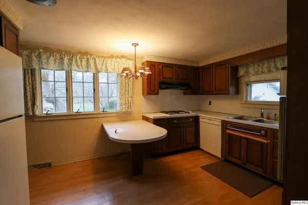 a kitchen with a sink appliances and cabinets
