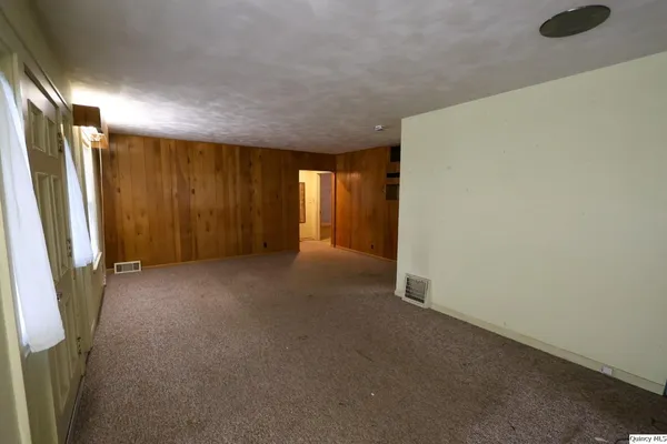 an empty room with closet area