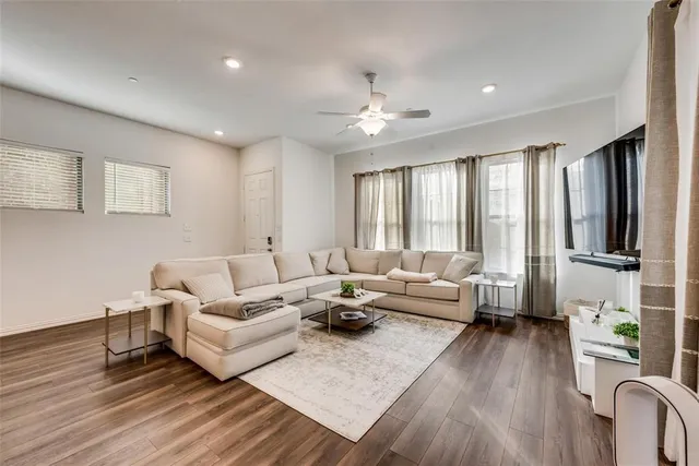 a living room with furniture or wooden floor and a window