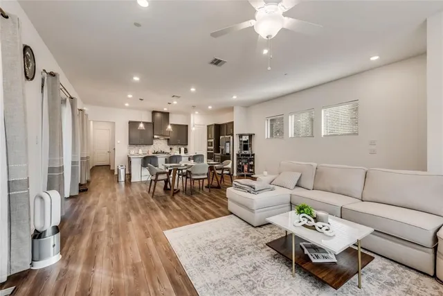 a living room with furniture and wooden floor