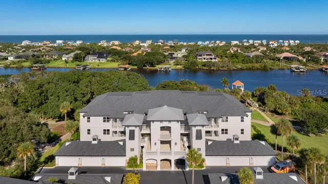 an aerial view of a house with a lake view