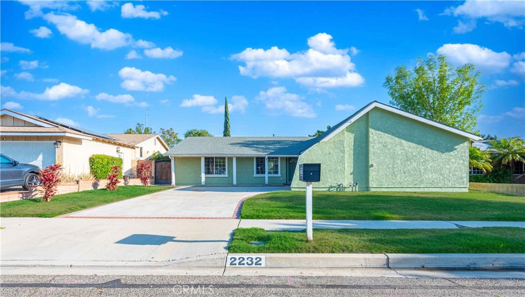 2232 Hawk Street Simi Valley, CA 93065 - Photo 3 of 39 a front view of a house with a yard and potted plants
