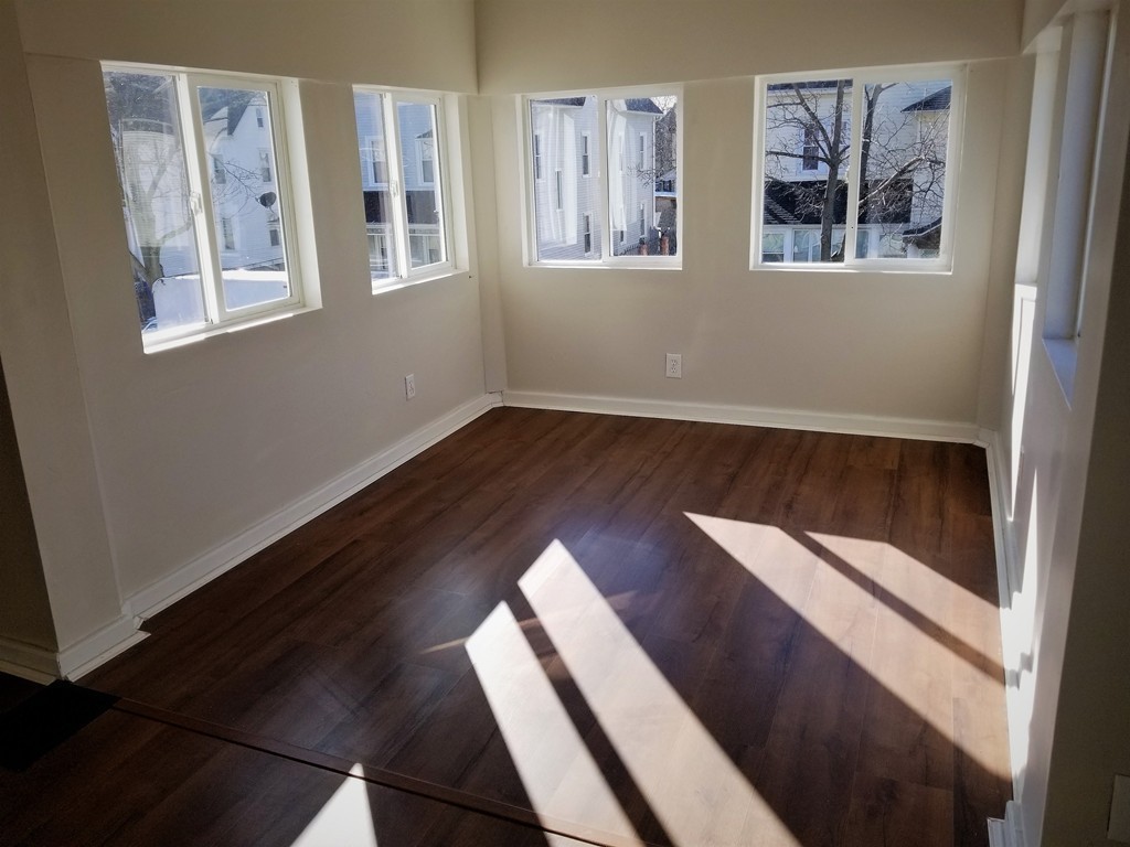 19 Merrick Avenue Springfield, MA 01109 - Photo 11 of 20 a view of an empty room with wooden floor and a window