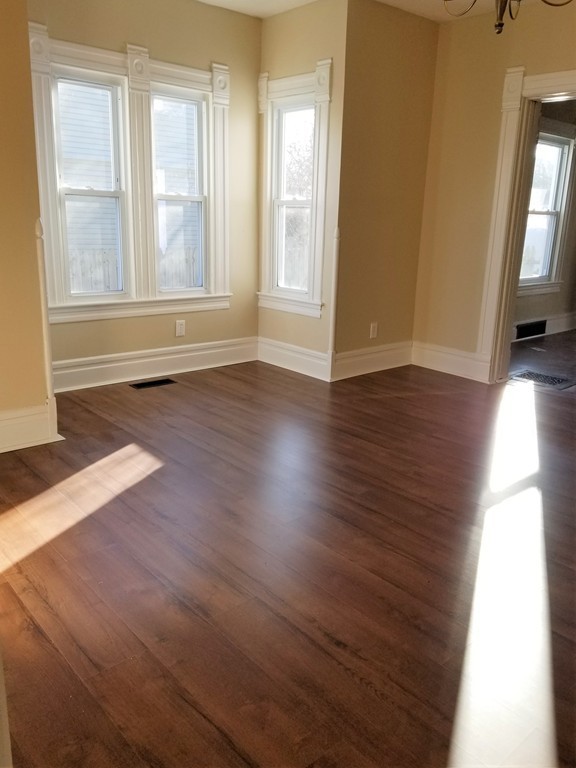 19 Merrick Avenue Springfield, MA 01109 - Photo 12 of 20 an empty room with wooden floor and windows