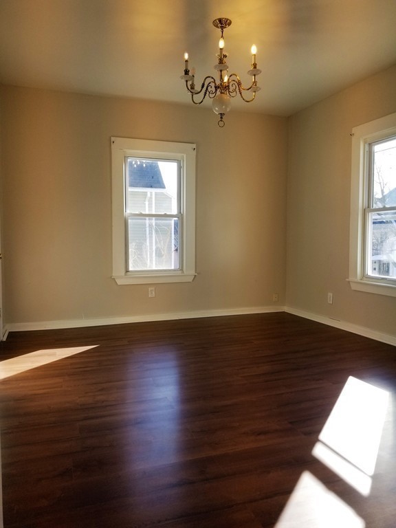 19 Merrick Avenue Springfield, MA 01109 - Photo 14 of 20 a view of a room with wooden floors and chandelier