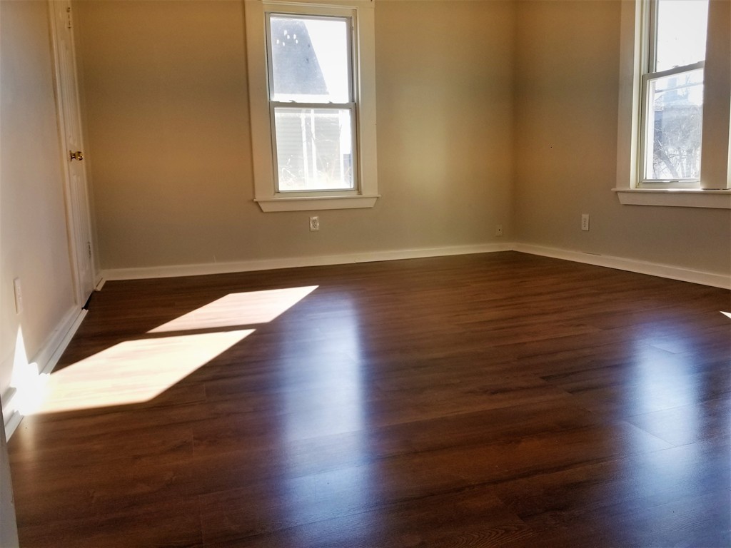 19 Merrick Avenue Springfield, MA 01109 - Photo 17 of 20 an empty room with wooden floor and windows