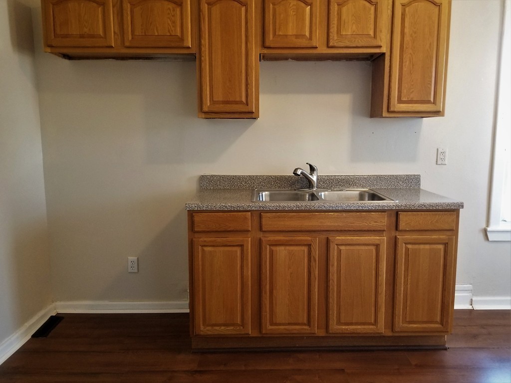 19 Merrick Avenue Springfield, MA 01109 - Photo 18 of 20 a bathroom with granite countertop a sink and cabinets