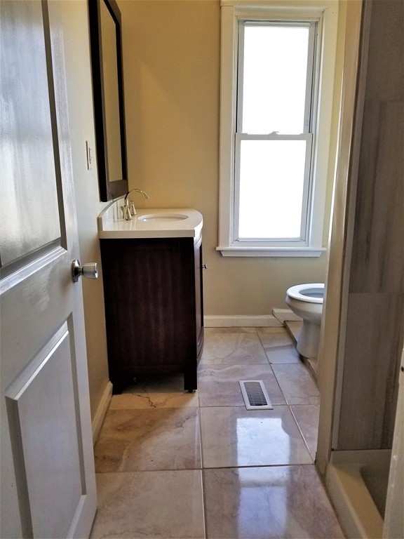19 Merrick Avenue Springfield, MA 01109 - Photo 4 of 20 a bathroom with a sink a toilet and a mirror