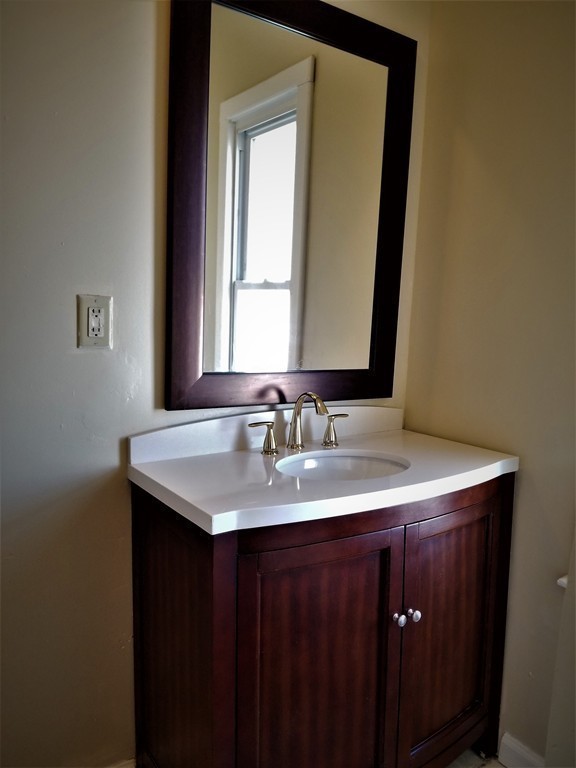 19 Merrick Avenue Springfield, MA 01109 - Photo 6 of 20 a bathroom with a granite countertop sink and a mirror