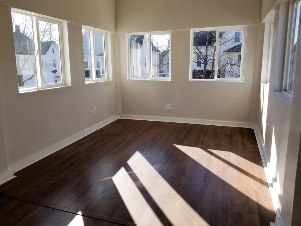 19 Merrick Avenue Springfield, MA 01109 - Photo 9 of 20 a view of an empty room with wooden floor and a window