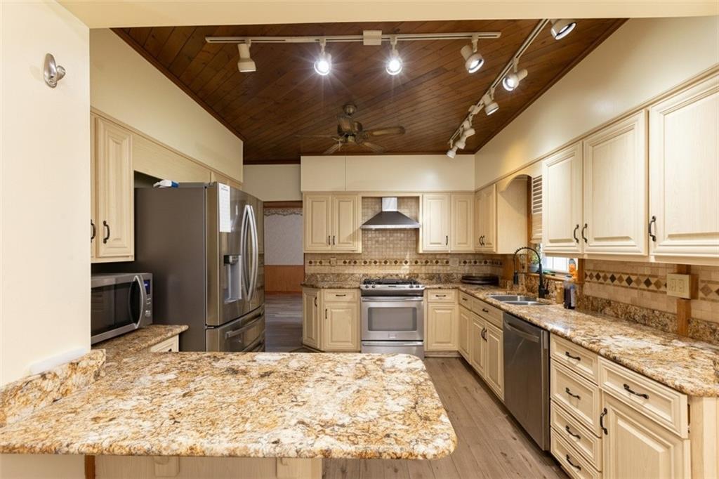 37 Redstone Street Republic, PA 15475 - Photo 5 of 19 a large kitchen with stainless steel appliances kitchen island granite countertop a sink refrigerator and cabinets