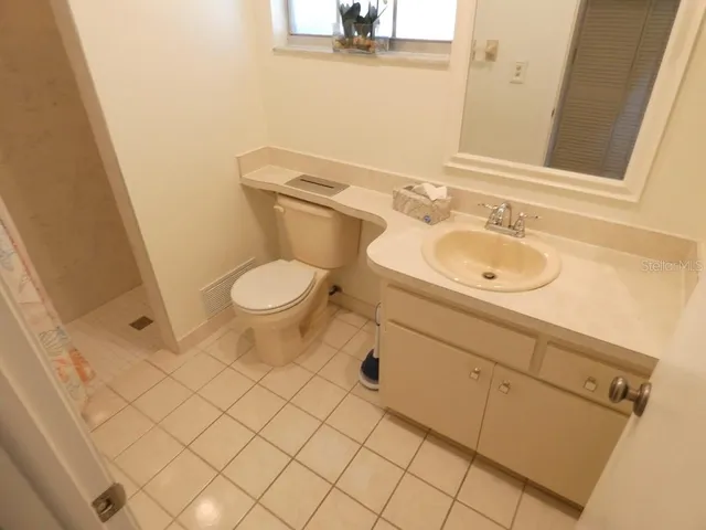 a bathroom with a toilet and shower