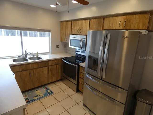 a kitchen with stainless steel appliances a refrigerator sink and cabinets
