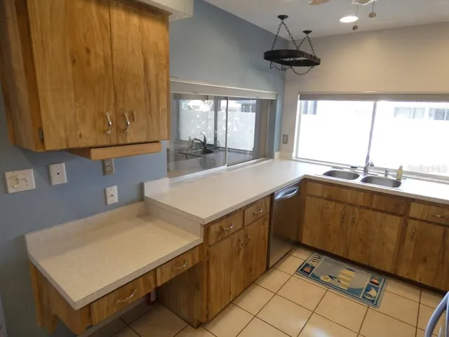 a kitchen with stainless steel appliances a refrigerator and a stove top oven