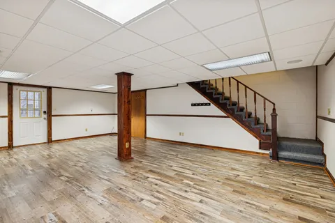 a view of a livingroom with wooden floor and a ceiling fan