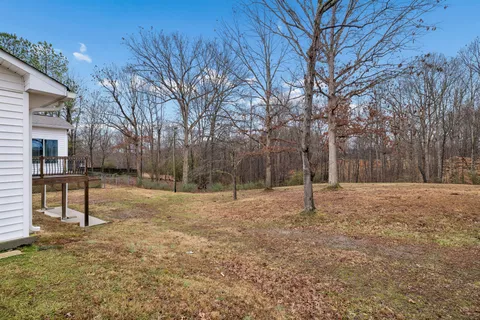 a view of empty room with tree and wooden fence