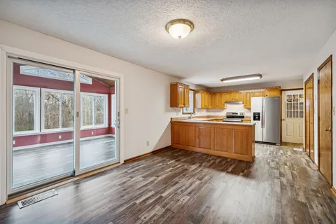 a view of kitchen with sink and refrigerator