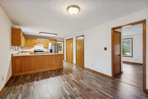 a kitchen with stainless steel appliances granite countertop a stove a sink and a refrigerator