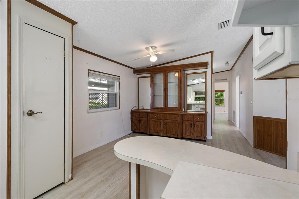 701 Helmsman Lane Edgewater, FL 32141 - Photo 18 of 73 a room with a bed a mirror on the wall and a dresser