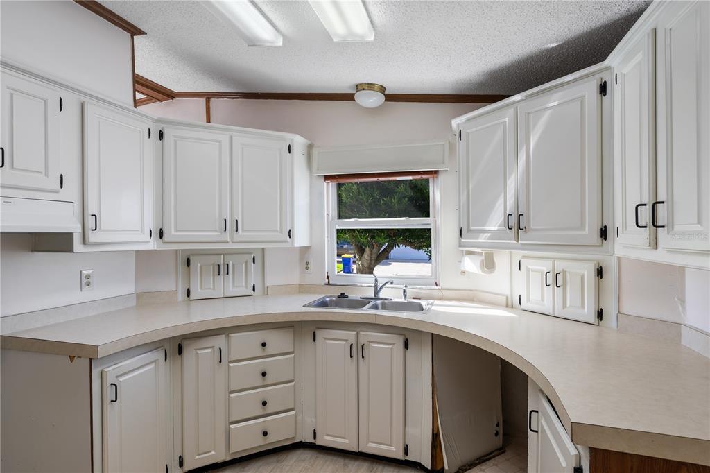 701 Helmsman Lane Edgewater, FL 32141 - Photo 20 of 73 a kitchen with cabinets appliances a sink and a counter top space