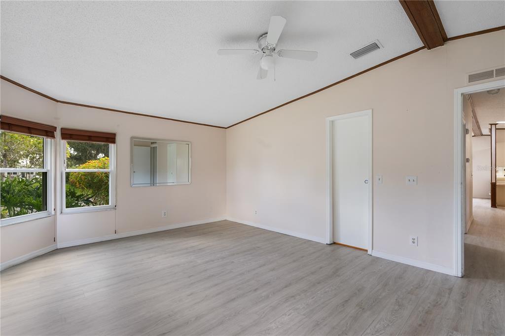 701 Helmsman Lane Edgewater, FL 32141 - Photo 23 of 73 an empty room with wooden floor and windows