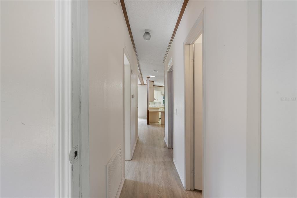701 Helmsman Lane Edgewater, FL 32141 - Photo 35 of 73 a view of a hallway with wooden floor and entryway