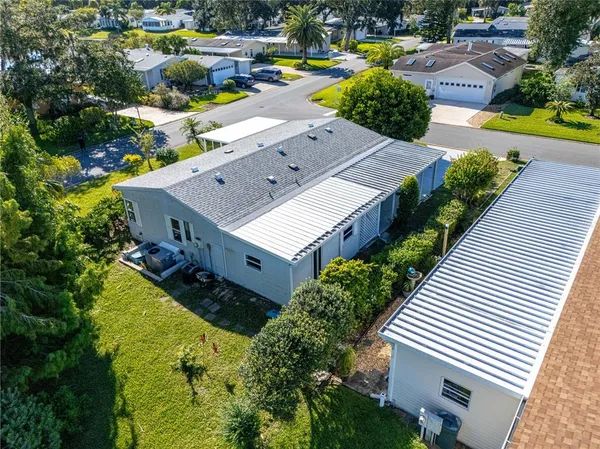 a view of backyard of house with green space