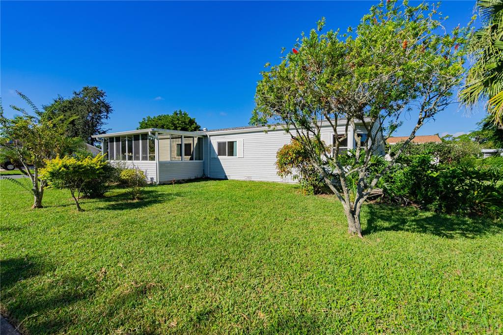 701 Helmsman Lane Edgewater, FL 32141 - Photo 65 of 73 a house view with a garden space