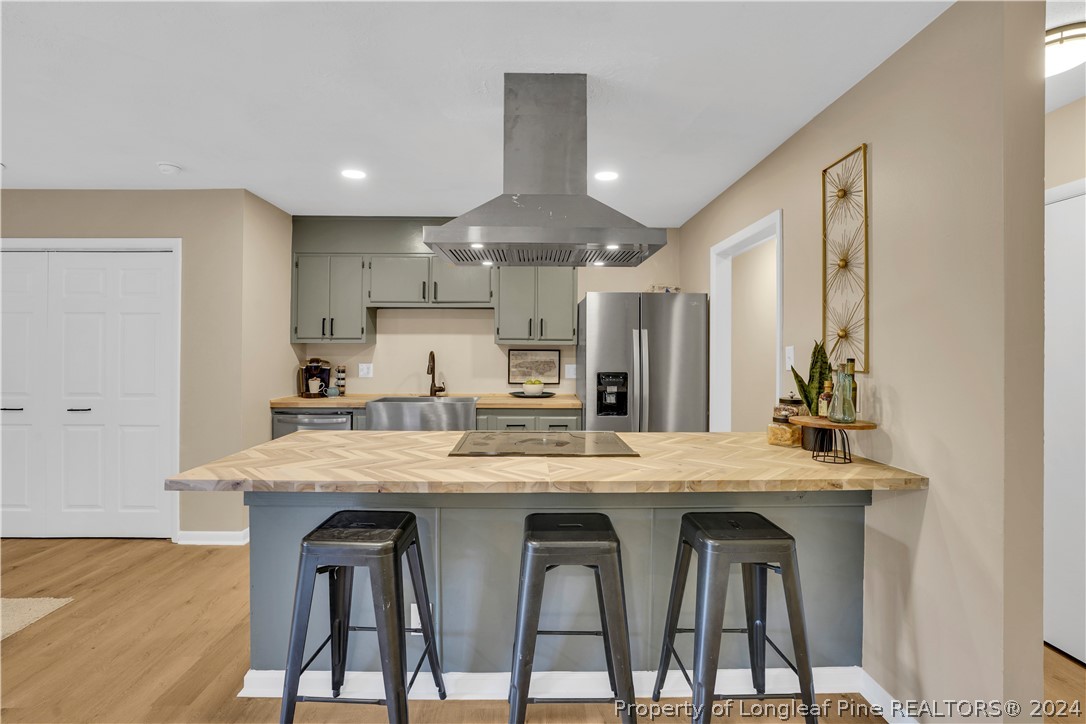 2540 Graham Road Fayetteville, NC 28304 - Photo 11 of 22 a kitchen with stainless steel appliances kitchen island a table chairs sink and cabinets