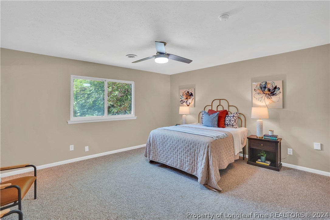 2540 Graham Road Fayetteville, NC 28304 - Photo 12 of 22 a bedroom with a bed and a chandelier