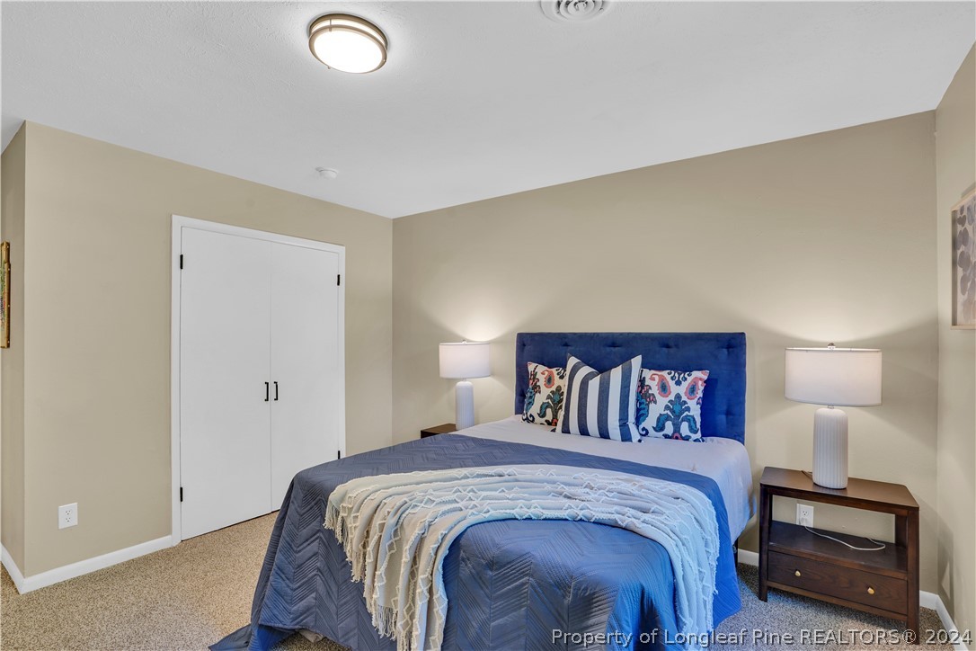 2540 Graham Road Fayetteville, NC 28304 - Photo 19 of 22 a bedroom with a bed and a lamp