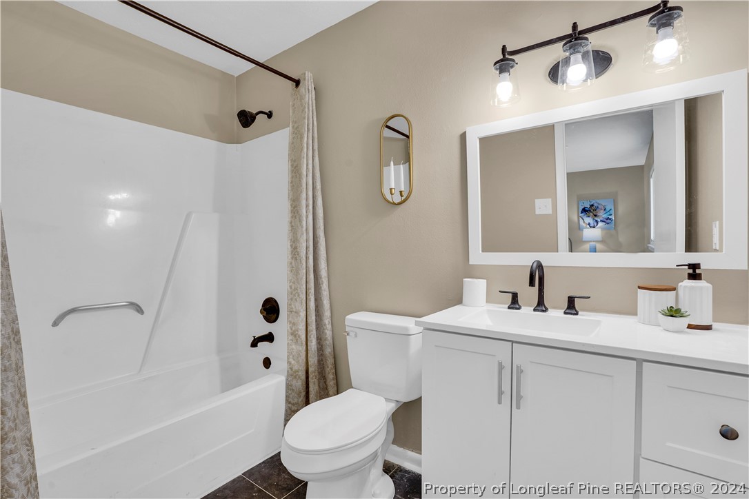 2540 Graham Road Fayetteville, NC 28304 - Photo 21 of 22 a bathroom with a sink toilet vanity tub and shower