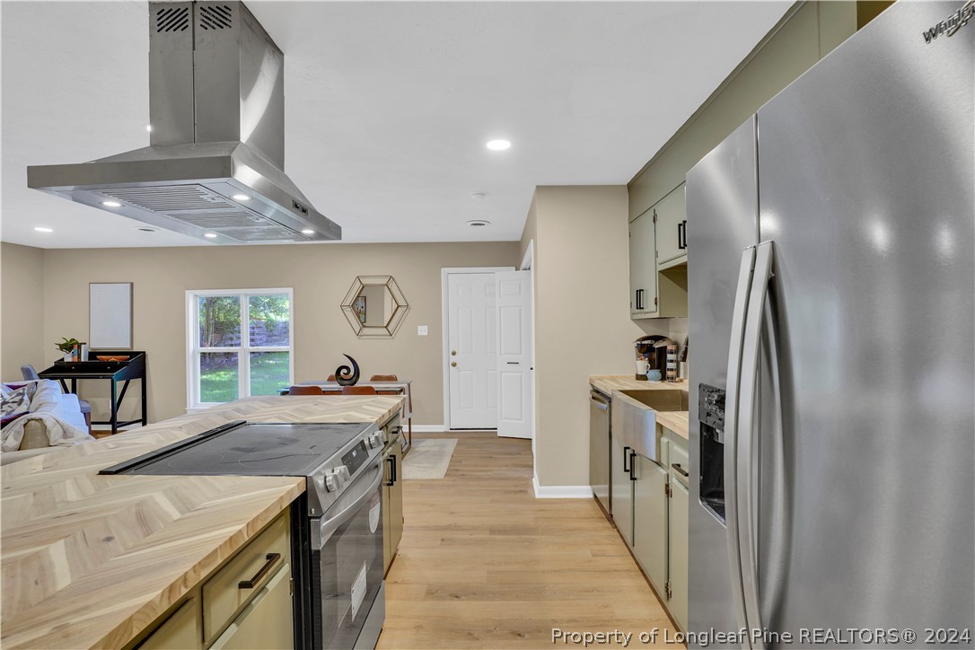2540 Graham Road Fayetteville, NC 28304 - Photo 4 of 22 a kitchen with a stove a refrigerator and a sink