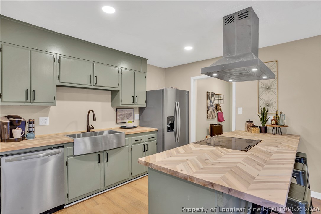 2540 Graham Road Fayetteville, NC 28304 - Photo 5 of 22 a kitchen with white cabinets and stainless steel appliances