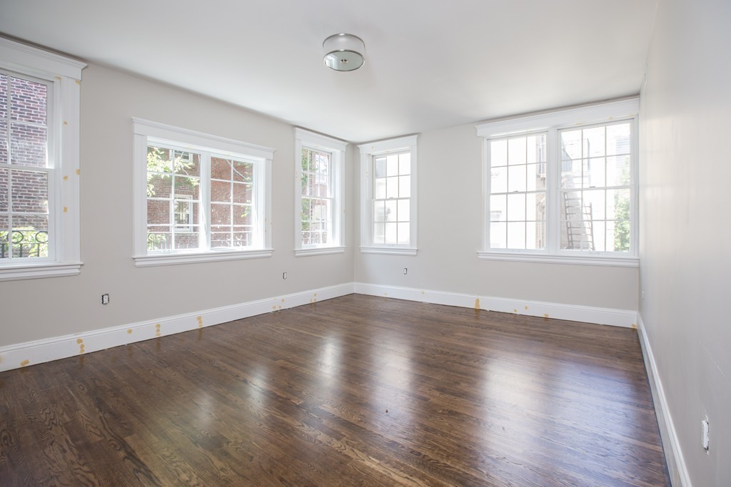 290 North Street, Unit 2 Boston, MA 02113 - Photo 2 of 8 an empty room with wooden floor and windows