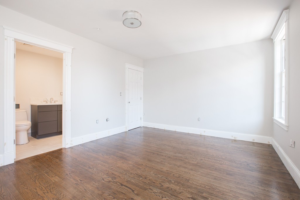 290 North Street, Unit 2 Boston, MA 02113 - Photo 5 of 8 an empty room with wooden floor and windows