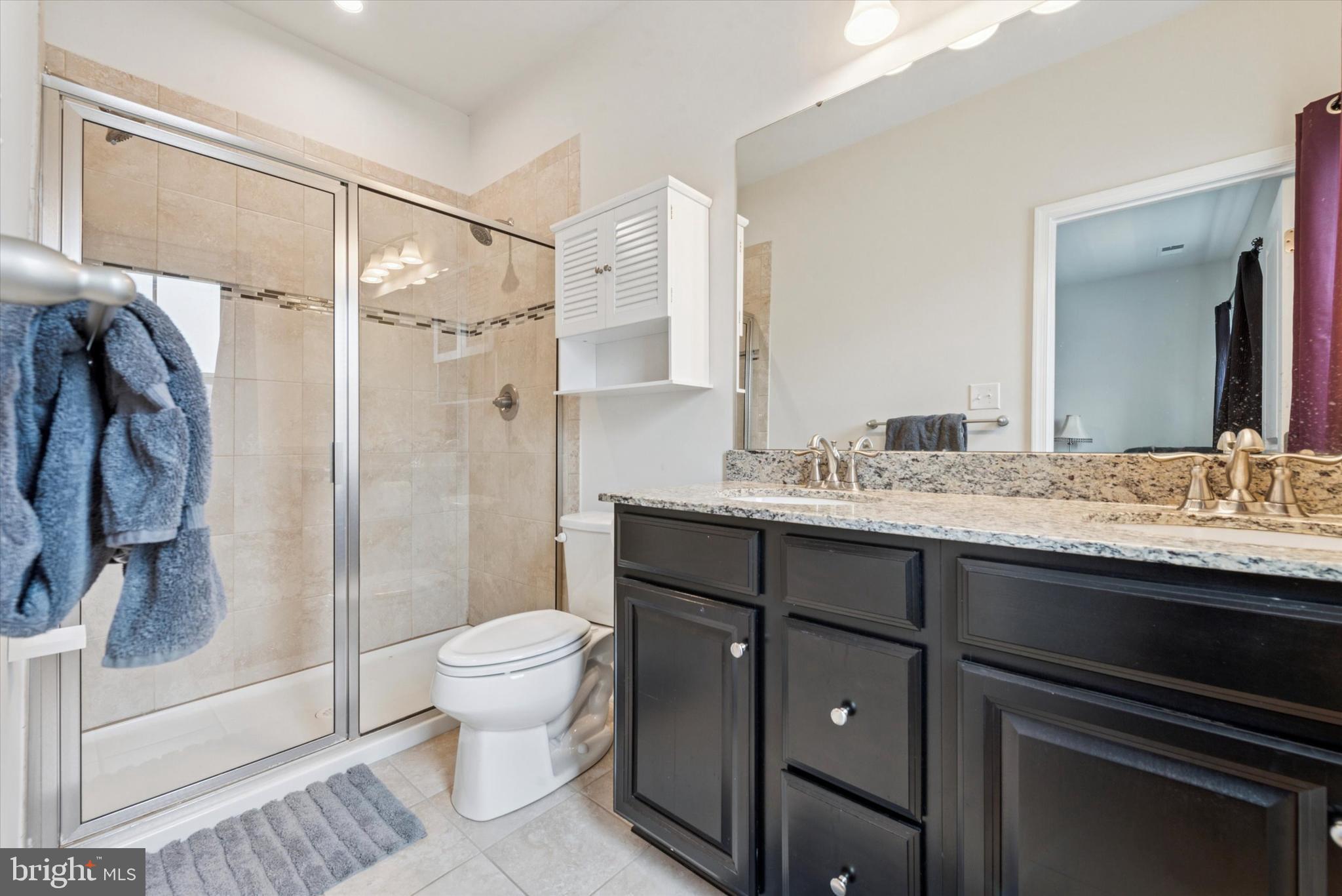 515 Quarry Point Road Malvern, PA 19355 - Photo 17 of 25 a bathroom with a granite countertop sink toilet and shower