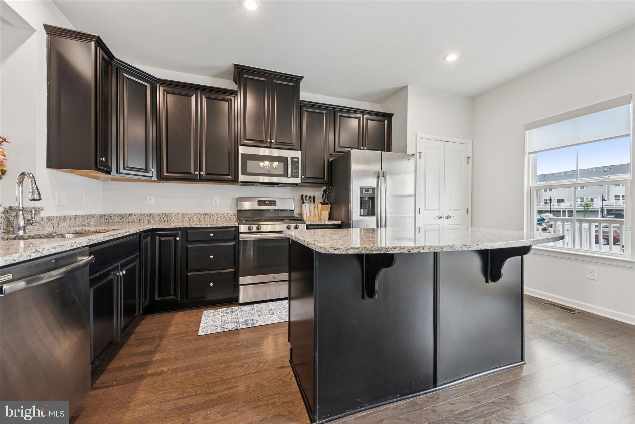 515 Quarry Point Road Malvern, PA 19355 - Photo 8 of 25 a kitchen with stainless steel appliances granite countertop a stove refrigerator sink and cabinets