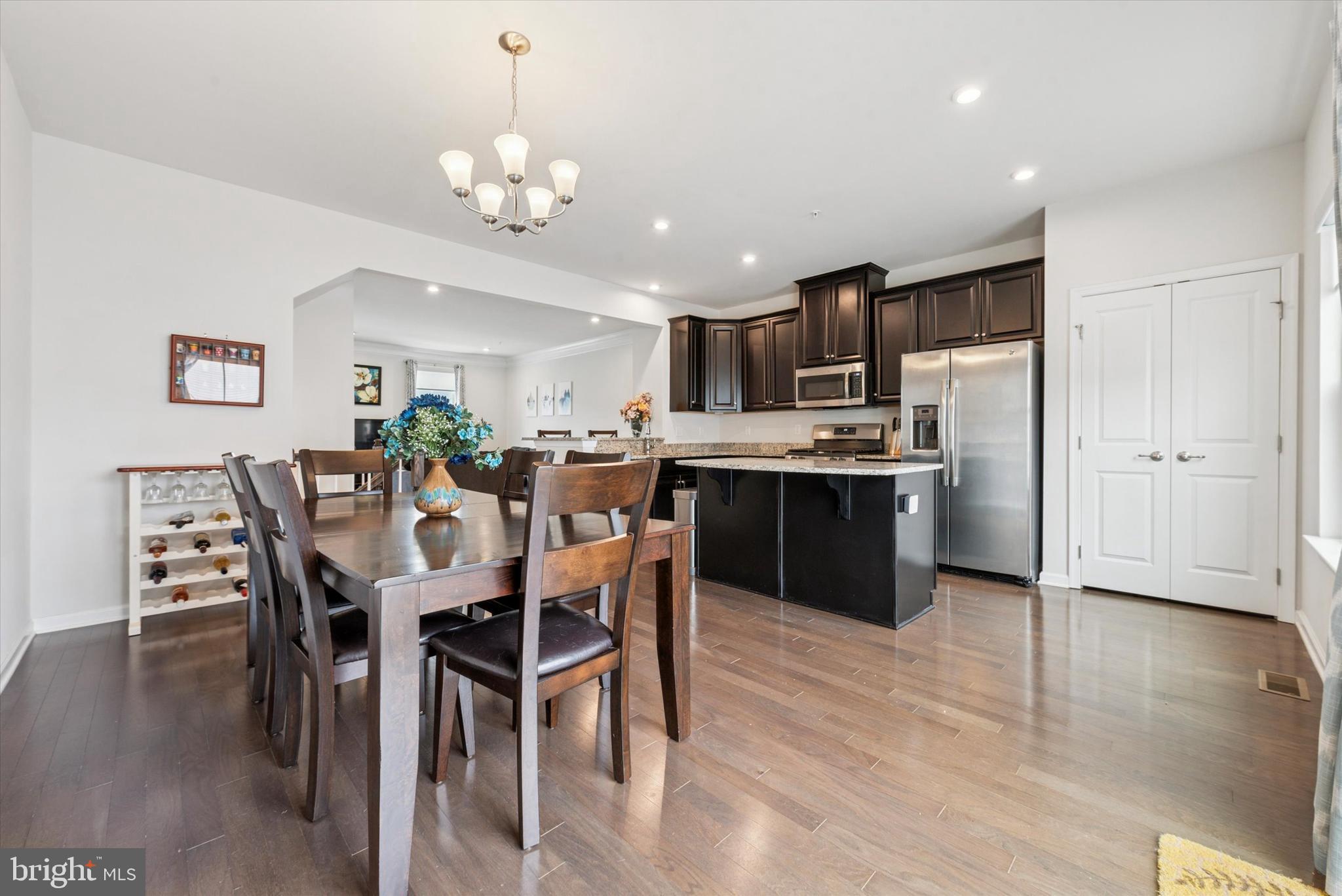515 Quarry Point Road Malvern, PA 19355 - Photo 10 of 25 a dining room with stainless steel appliances kitchen island granite countertop a table chairs and a refrigerator
