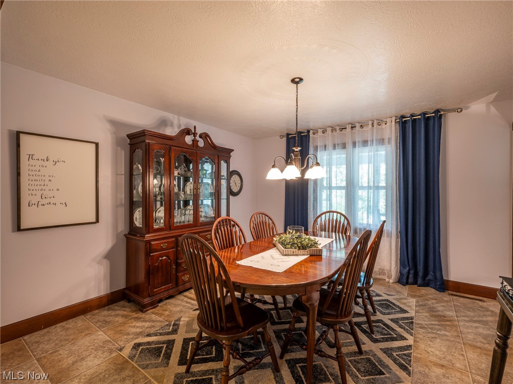 9452 Pleasant Hill Road Northwest Dundee, OH 44624 - Photo 12 of 35 Dining area featuring tile flooring and a textured ceiling