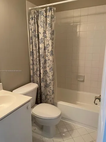 a bathroom with a toilet and shower