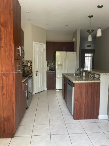 a kitchen with stainless steel appliances a refrigerator and a stove