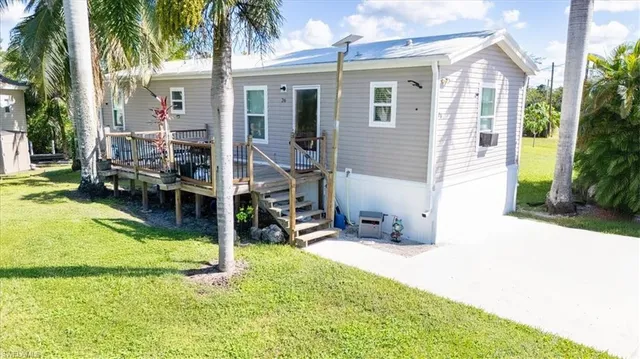 a view of a house with backyard porch and sitting area