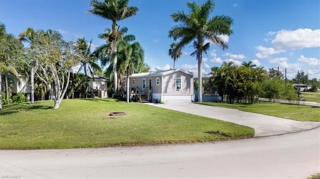 a view of a patio with table and chairs with wooden floor and fence